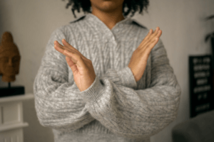 Person making an X gesture with crossed arms, representing an employee refusal to test under DOT drug and alcohol testing regulations and the DER's required response protocol.